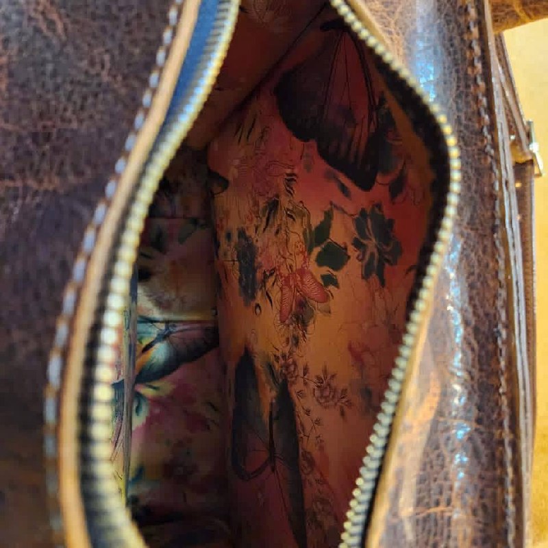 Detailed view inside a handmade leather purse with floral lining