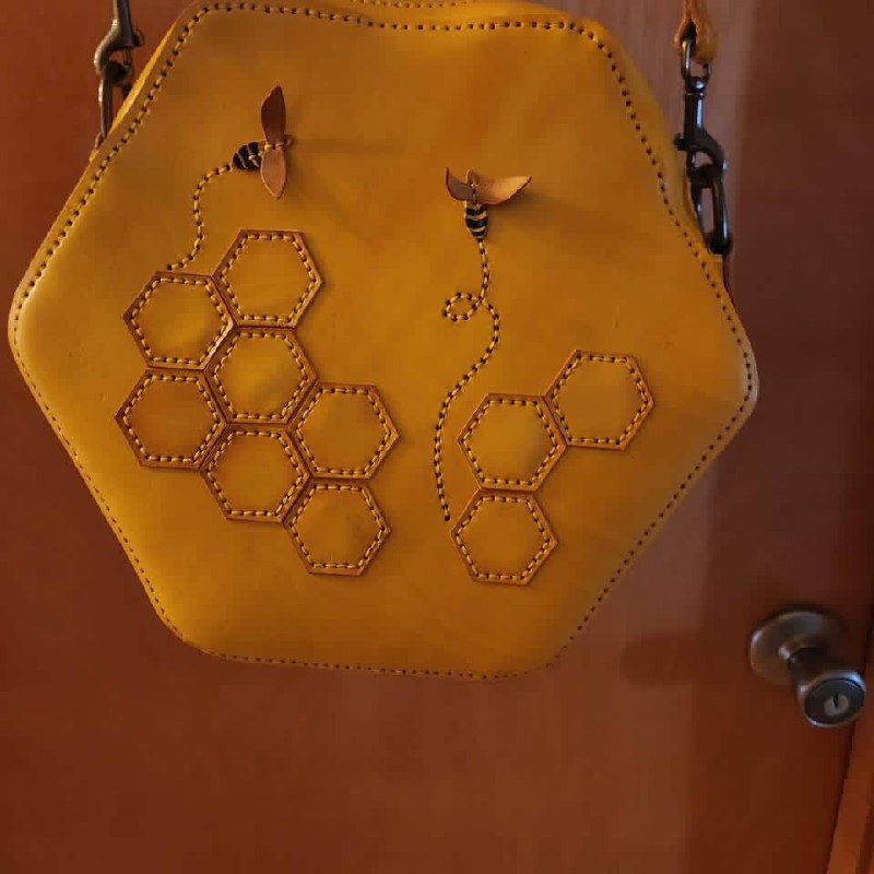Honeycomb-shaped handmade yellow leather purse with bee detail